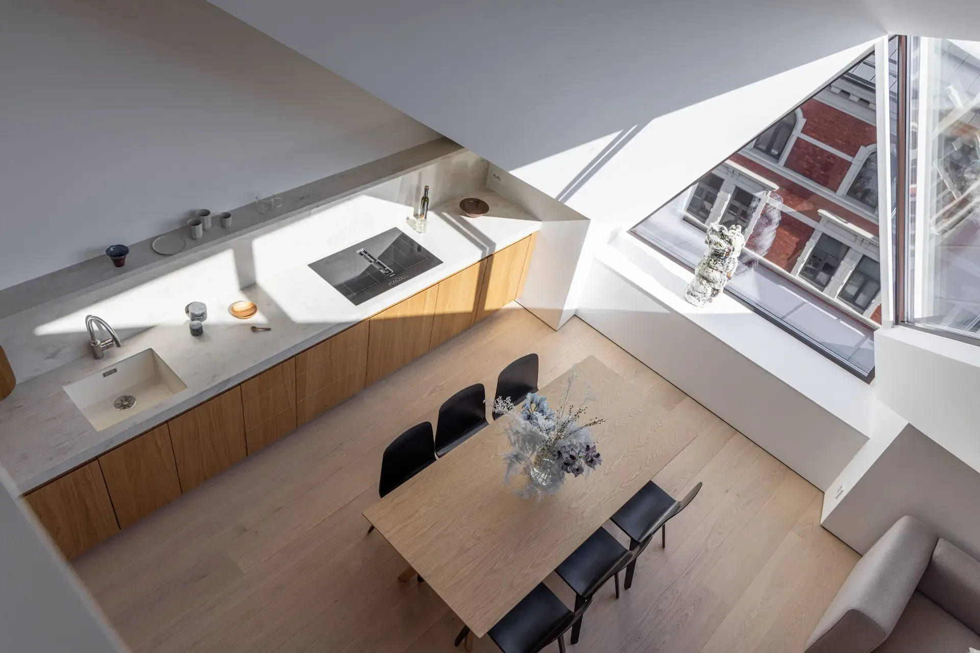 Kitchen and dining zone in Scandinavian loft apartment on Huitfeldts gate in Oslo